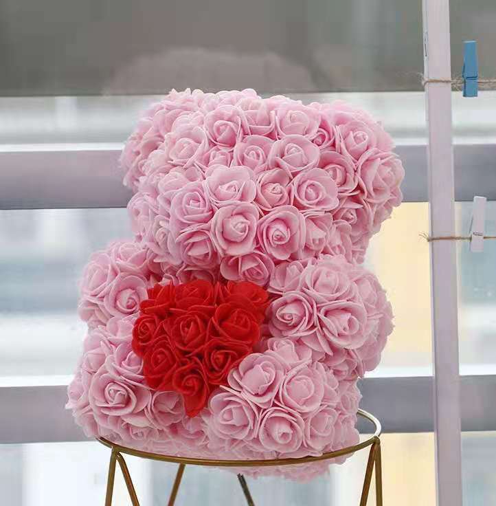 fat pink bear with red heart with box