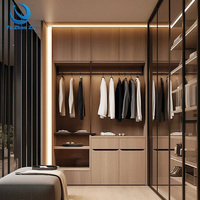 Dressing en L avec portes coulissantes en verre, éclairage dissimulé et intégration chambre pour suite parentale