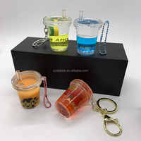 Adorable porte-clés en acrylique transparent rempli d'huile, avec perle flottante pour thé aux bulles, idéal comme souvenir et accessoire de vente au détail