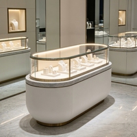 Vitrine de luxe personnalisée pour bijoux avec dessus en verre incurvé, éclairage LED et base verrouillable pour la vente de montres et de bijoux, armoire à bijoux