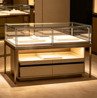 Vitrine d'îlot de luxe en métal pour bijoux, avec éclairage LED et tiroirs de rangement, idéale pour la présentation de montres et de diamants en boutique