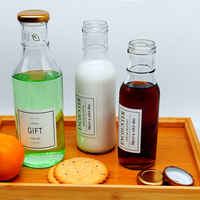 Bouteille d'emballage en verre transparent rond avec logo personnalisé pour les boissons thé à la maison Kombucha saveur jus de fruits avec bouchon métallique torsadé