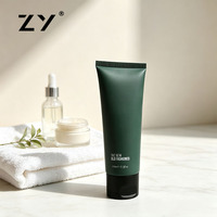Tube souple en plastique vert foncé mat avec bouchon à clapet pour nettoyant visage, lotion mains et corps