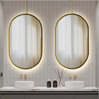 Miroir mural en verre avec cadre en aluminium de forme ovale au design de luxe Miroir de courtoisie mural désembué à commande tactile avec lumière LED