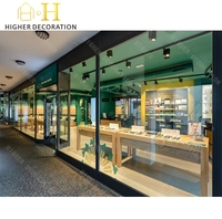 Vitrine de présentation de lunettes de style industriel vert foncé pour magasin d'optique, comptoir en verre, meuble de présentation pour lunettes