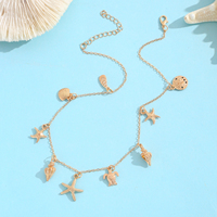 Collier chaîne en or avec 9 breloques marines : étoile de mer, tortue, dollar de sable, conque – Bijoux de plage tendance bohème pour femme
