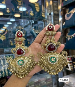 Premium Golden Jhumka Earrings Adorned with <b>Emerald</b> Green Center Stone and Small White Pearls Ethnic Bridal Fashion Jewelry - Product Image 1