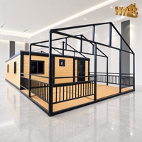 Maison conteneur moderne pliable en kit avec revêtement imitation bois, pavillon et terrasse, 2 chambres, pour glamping, gîte, école, boutique