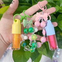Vente en gros de porte-clés hydratant et changeant de couleur, brillant à lèvres, huile repulpante, bracelet détachable, baume à lèvres hydratant