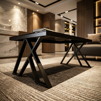 Table basse élégante noire brillante avec pieds en métal en forme de X géométrique pour un intérieur de bureau exécutif contemporain