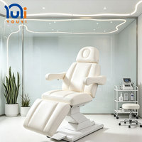 Table de beauté professionnelle électrique avec base en ABS, accoudoirs amovibles, appui-tête extensible et commande au pied