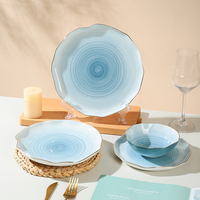Vente en gros Bol et assiette décoratifs en céramique pour salade et céréales à bord ondulé couleur orange et or
