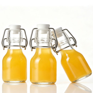 Bouteilles de shot de gingembre en verre réutilisables de 60 ml (2 oz) avec logo personnalisé, petits contenants hermétiques pour shots sains, avec bouchons pivotants hermétiques - Product Image 1