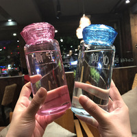 Nouvelle conception de bouteille en verre avec couvercle de style diamant, bouteille d'eau portable promotionnelle, cadeau, bouteille en verre transparente pour boire