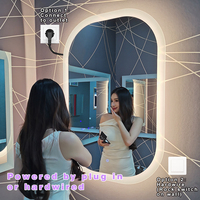 Miroir de salle de bain rétroéclairé personnalisé en usine, CCT 3000K-6000K, capteur tactile, montage mural ovale LED moderne IP44, prise murale pour chambre à coucher