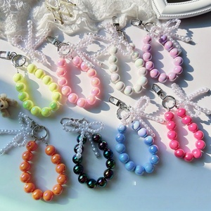 Breloques de téléphone pour filles tendance, avec perles, nœuds et perles de culture, utilisables comme porte-clés, chaîne de téléphone, dragonne ou bracelet. - Product Image 5