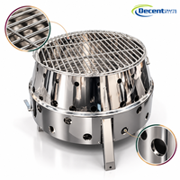 Poêle à bois en acier inoxydable en forme de tambour avec grille de cuisson, trois pieds et trous d'aération pour camping et jardin