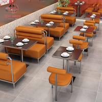 Ensemble de meubles modernes pour restaurant Cabine de canapé en cuir orange avec structure en métal et dessus de table commercial en marbre foncé pour café