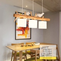 Lustre moderne japonais simple à LED Lampe de salle à manger en bois massif sur le thème des oiseaux pour table à manger à trois têtes à usage domestique