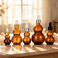 Bouteilles compte-gouttes en verre ambré en forme de gourde, résistantes à la lumière, pour le stockage d'huiles essentielles et l'utilisation cosmétique