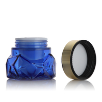 Pots de crème en verre bleu profond transparent à double paroi de conception spéciale de 50g avec bouchon à vis plaqué or et joint blanc