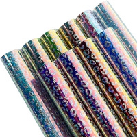Nouveau produit Rouleau de PVC transparent à motif léopard explosif de 0,1 mm, matériau vinyle magique de couleur transparente pour l'emballage décoratif