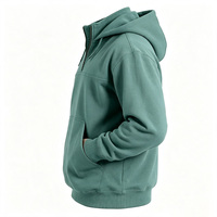 Sweat à capuche unisexe personnalisé vert sauge d'hiver avec fermeture éclair quart de tour, poche kangourou, col montant zippé en laiton, en polaire épais brodé