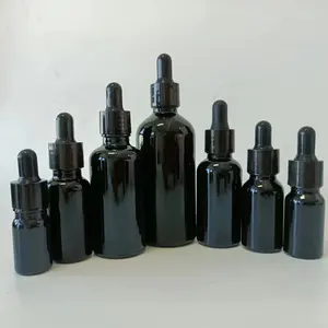 Vente en gros bouteille d'huile essentielle en verre transparent de 30ml de différentes couleurs sérum noir avec flacon compte-gouttes en verre emballage cosmétique en verre