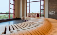 Banc modulaire avec accoudoirs, forme incurvée, matériaux durables pour les espaces publics intérieurs et extérieurs, bibliothèque