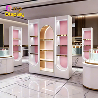 Vitrine de magasin de parfums et cosmétiques de luxe moderne haut de gamme en acier inoxydable avec éclairage LED, design écologique, dimensions personnalisables