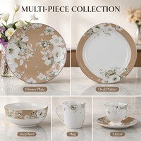 Service de table en porcelaine Bone China avec bordure dorée perlée, motif fleur blanche et feuille verte, comprenant assiette, bol, tasse, soucoupe, mug et plat de présentation