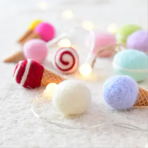 Wool felt ice cream decorated with colorful cone presents Christmas tree garlands and rattan decorations