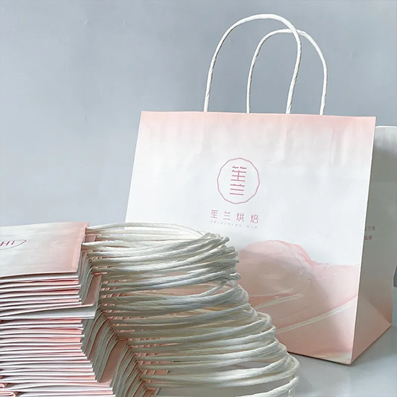 Bolsas de papel personalizadas de color rosa con su logogo tas kertas