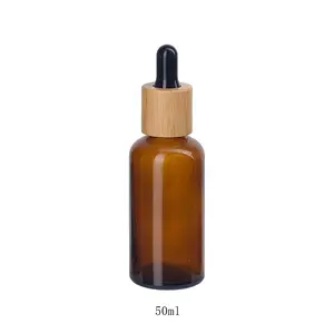 Bouteille d'huile essentielle en verre ambré 50ml bouteille cosmétique en verre de couleur marron avec compte-gouttes en bois de bambou de 18 mm pour les soins de la peau huile corporelle