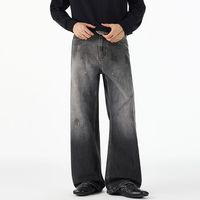 Jeans délavés tendance style américain avec motif encre rétro, coupe ample et droite, en denim