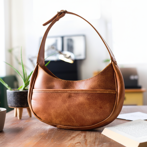 Bolso Hobo. Bolso de hombro marrón curvo e informal con un acabado desgastado. Disponible a precios mayoristas - Product Image 1