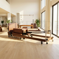 Machine de Pilates pliable de haute qualité avec cadre en chêne rouge massif et finition noyer pour l'utilisation en studio de Pilates