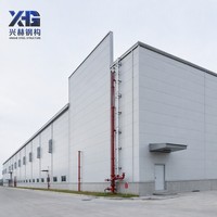 Entrepôt préfabriqué en structure métallique ignifugée, bâtiment métallique avec panneaux en laine de roche, conforme aux normes de la protection incendie