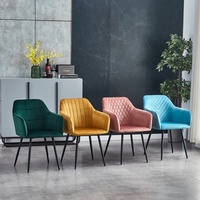 Fauteuil de salle à manger élégant et luxueux en velours gris avec pieds en métal noir et coussin
