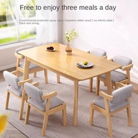Ensemble table et chaises de salle à manger en bois massif moderne et durable pour 6 personnes, idéal pour les petits appartements et les salons.
