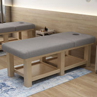 Table de massage pliable de salon commerciale moderne et luxueuse avec cadre en bois massif, acier inoxydable et revêtement en cuir synthétique, avec appui-tête intégré