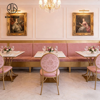 Elegante Franse roze fluwelen bankzittingen met gouden frame, tafel en stoelen van gesinterd steen, meubelset voor koffieshop en restaurant