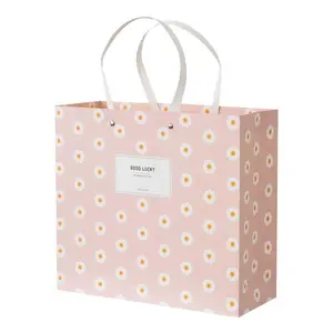 Tas ritel pakaian mewah kustom tas hadiah merah muda tas kertas kemasan belanja dengan pegangan untuk pakaian