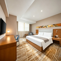 Ensemble de mobilier moderne pour chambre double d'hôtel : lit avec tête de lit capitonnée en placage de bois, chevet et fauteuil de détente