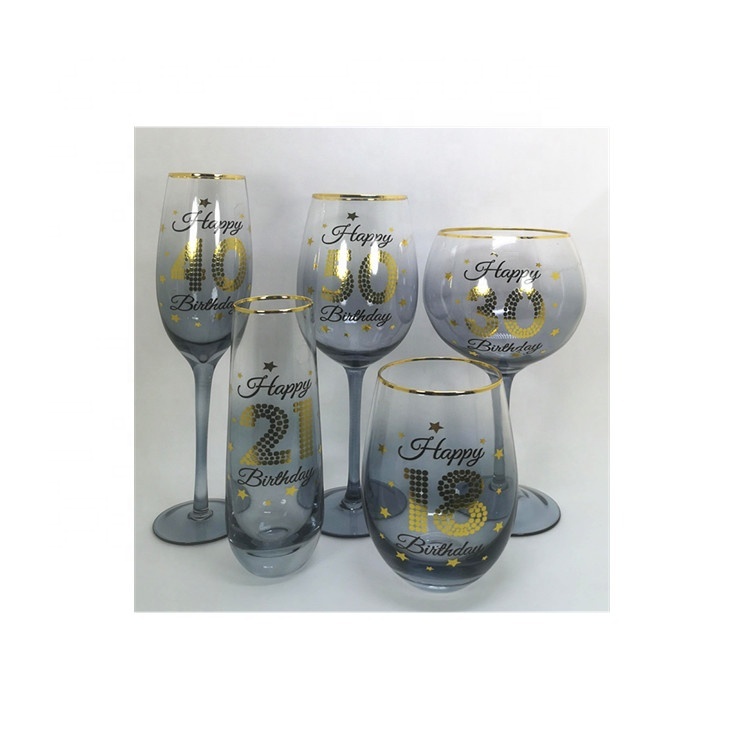 Sprayed glass globe gin tonic glass with gold edge and different ages birthday sticker