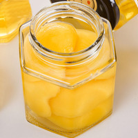 Vente en gros de pots en verre hexagonaux pour miel/confiture de 100 ml et 500 ml, emballage hexagonal, pot à miel avec couvercles en métal noir et or