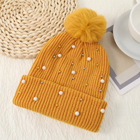 Femmes de haute qualité hiver tricoté acrylique pull couleur unie fourrure Pom Logo personnalisé chaud perle marque en gros pour une utilisation à la plage