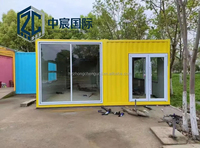 Maison conteneur jaune et noire à deux étages Zhongchen avec façade en verre, bâtiment modulaire préfabriqué pour magasin de détail