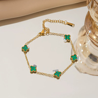 Bracelet de haute qualité, classique, en acier inoxydable plaqué or, double face, à quatre pétales de fleurs, adapté aux hommes et aux femmes