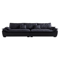 Canapé modulaire en tissu anthracite deux places en forme de L avec assise profonde, coussins d'accoudoir et dossier pour salon, villa, espace lounge contemporain